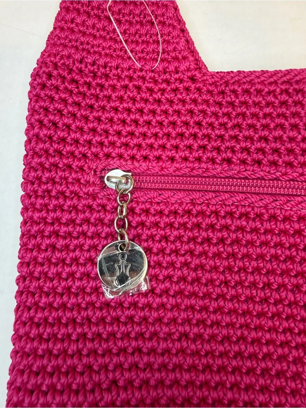 The Sak raspberry, pink handcrafted crochet hobo shoulder bag